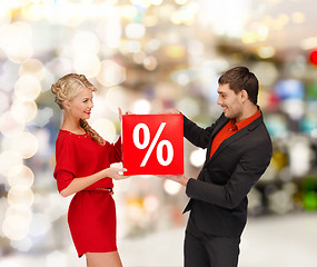 Image showing smiling woman and man with red percent sale sign