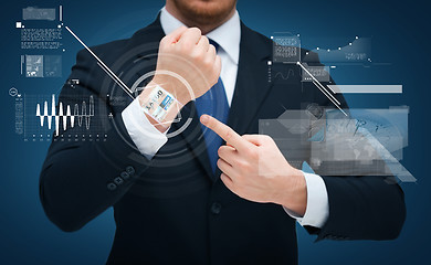 Image showing businessman pointing to something at his hand