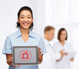 Image showing smiling female doctor or nurse with tablet pc
