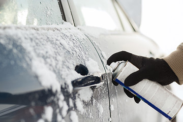 Image showing closeup of man hand with lock door de-icer