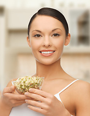 Image showing healthy woman holding bowl with sprout