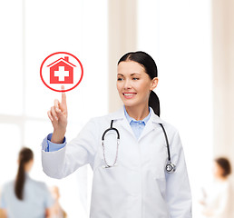 Image showing smiling female doctor pointing to something