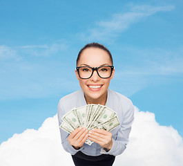 Image showing smiling businesswoman with dollar cash money