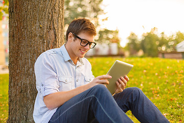 Image showing smiling male student in eyeglasses with tablet pc