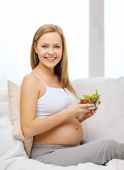 Image showing happy pregnant woman with bowl of salad
