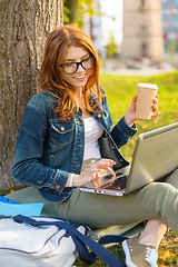 Image showing teenager in eyeglasses with laptop and coffee