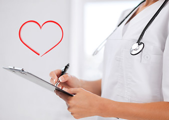 Image showing female doctor with stethoscope and prescription