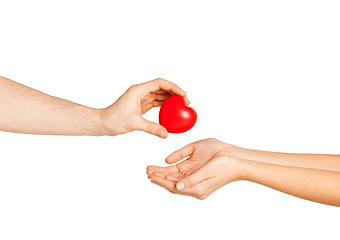 Image showing man hand giving red heart to woman