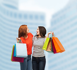 Image showing two smiling teenage girls with shopping bags