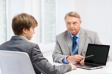 Image showing older man and young man with laptop computer