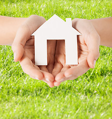 Image showing female hands holding paper house