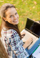 Image showing smiling teenager with laptop