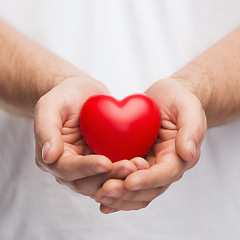 Image showing mans cupped hands showing red heart