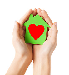 Image showing hands holding green paper house