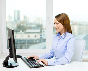 Image showing smiling businesswoman or student with computer