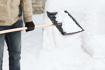 Image showing closeup of man shoveling snow from driveway