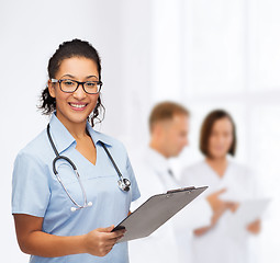 Image showing smiling female african american doctor or nurse