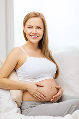 Image showing happy pregnant woman touching her belly