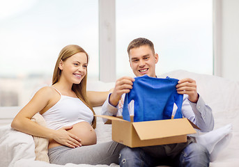 Image showing happy family expecting child opening parcel box