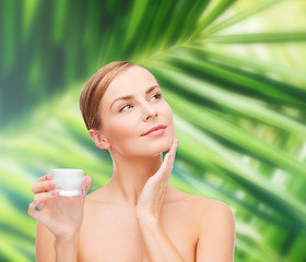 Image showing woman applying cream on her skin