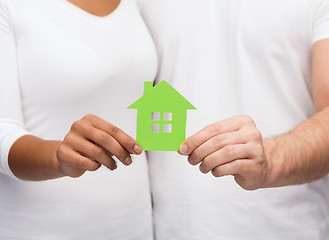 Image showing couple hands holding green house