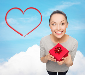 Image showing smiling asian woman with red gift box