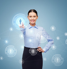 Image showing smiling businesswoman pointing finger at you