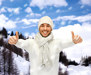 Image showing handsome man in warm sweater, hat and scarf