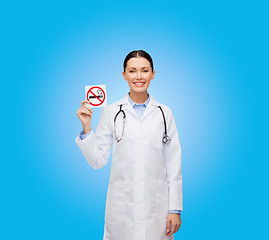 Image showing smiling female doctor holding no smoking sign