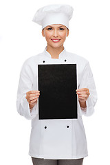 Image showing smiling female chef with black blank paper