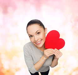 Image showing smiling asian woman with red heart