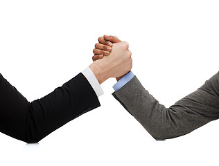 Image showing businessman and businesswoman wretsling on table