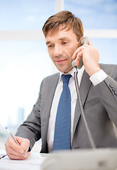 Image showing businessman with phone and documents