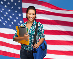 Image showing smiling student with folders, tablet pc and bag