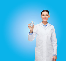 Image showing smiling female doctor with pills