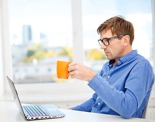 Image showing man working with laptop at home