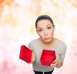 Image showing disappointed asian woman with empty red gift box