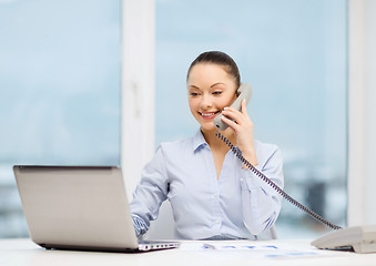 Image showing businesswoman with phone, laptop and files