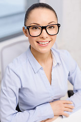 Image showing smiling businesswoman in eyeglasses in office