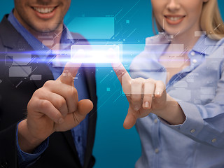 Image showing man and woman hands pointing at virtual screen