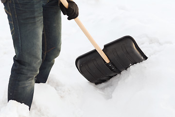 Image showing closeup of man shoveling snow from driveway