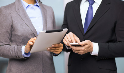 Image showing two businesspeople with smartphone and tablet pc