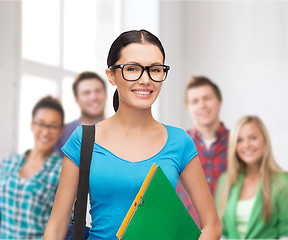 Image showing smiling student with bag and folders