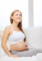 Image showing happy pregnant woman touching her belly