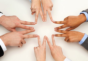 Image showing group of businesspeople showing v-sign