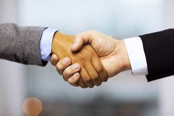 Image showing businessman and businesswoman shaking hands