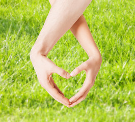 Image showing woman and man hands showing heart shape