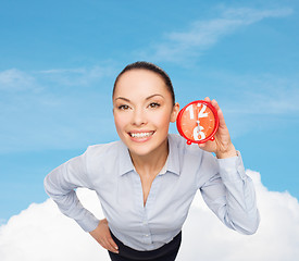 Image showing smiling businesswoman with red clock