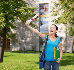 Image showing smiling student with bag and folders