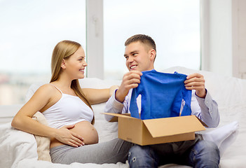 Image showing happy family expecting child opening parcel box